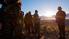 Kenyan Police officers look over the vally on November 15, 2012where the mass killings of police took place in Samburu north district near Baragoi . Some of the remaining four bodies where found close to where the ambush took place by alleged Turkana c...