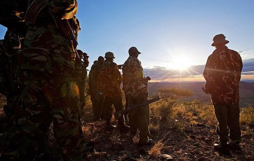 Kenyan Police officers look over the vally on November 15, 2012where the mass killings of police took place in Samburu north district near Baragoi . Some of the remaining four bodies where found close to where the ambush took place by alleged Turkana c...