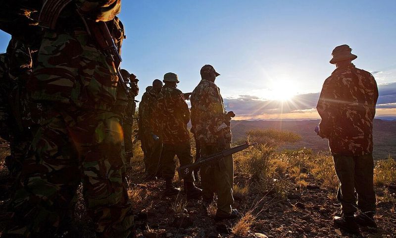 Kenyan Police officers look over the vally on November 15, 2012where the mass killings of police took place in Samburu north district near Baragoi . Some of the remaining four bodies where found close to where the ambush took place by alleged Turkana c...