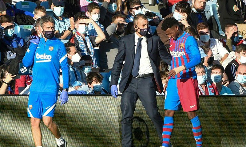 Barcelona's Spanish forward Ansu Fati  (right) limping off against Celta Vigo.