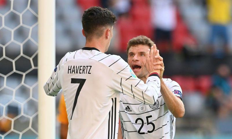 Kai Havertz (L) and Thomas Mueller (R) celebrate Germany's opening goal against Portugal