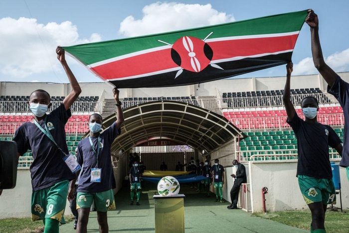 Boys enter with Kenya's national flag before the FIFA World Cup 2022 qualifier football match between Kenya and Mali at Nyayo national stadium in Nairobi on October 10, 2021. (Photo by YASUYOSHI CHIBA/AFP via Getty Images)
