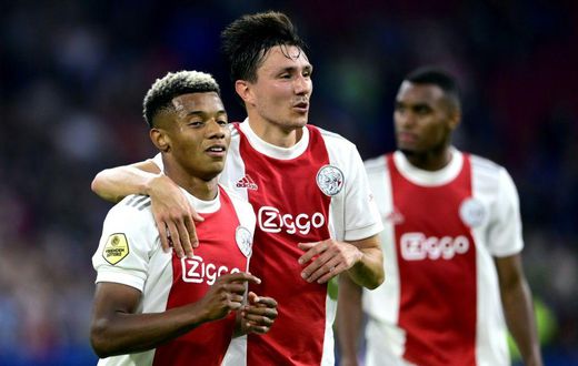 Easy does it: Ajax's David Neres and Steven Berghuis celebrate their fourth goal