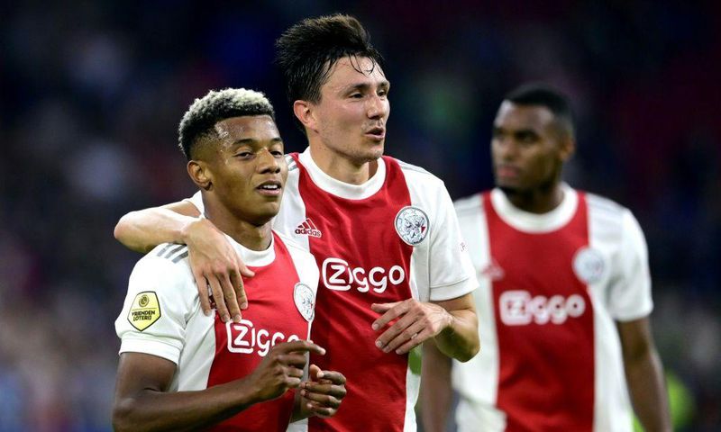 Easy does it: Ajax's David Neres and Steven Berghuis celebrate their fourth goal