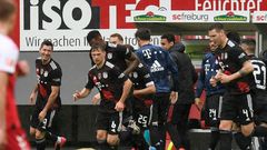 Bayern Munich striker Robert Lewandowski (L) celebrates scoring his 40th Bundesliga goal this season to equal Gerd Mueller's 49-year-old record