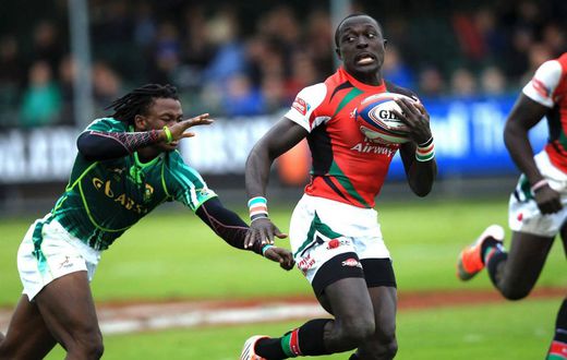 Legendary Kenya 7s rugby Utility Back Collins Injera swiftly evades a challenge from South African scrum half Branco du Preez in a past rugby tournament.