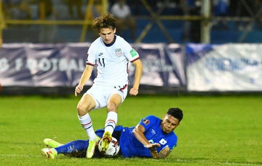 El Salvador's Ronald Rodríguez and USA's Brenden Aaronson contest a challenge in Thursday's World Cup qualifier