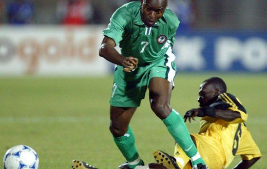Enyimba coach Finidi George (L) playing for Nigeria against Ghana during the 2002 Africa Cup of Nations in Mali.