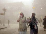 A photo of people, covered in dust from the collapsed World Trade Center buildings, on September 11, 2001.