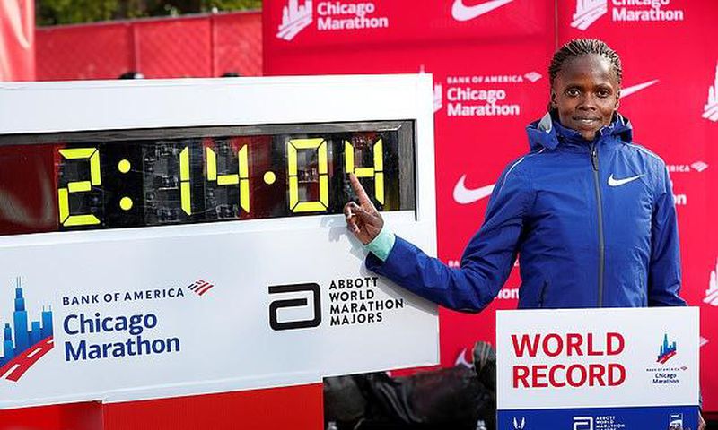 Brigid Kosgei poses next to her new world record.