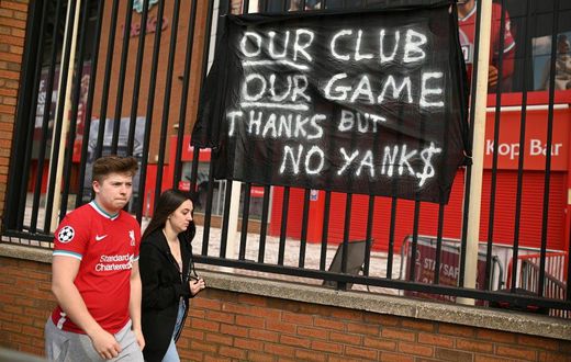 Supporters protest against Liverpool's US owner John W. Henry and the Fenway Sports Group