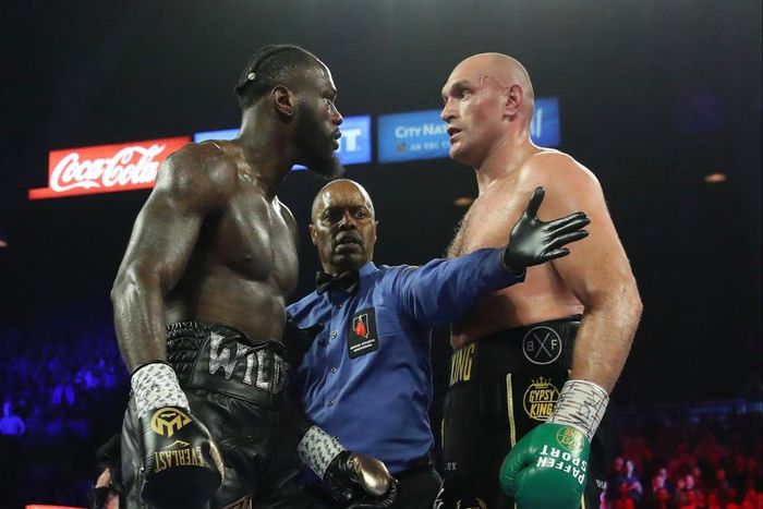 American boxer Deontay Wilder in the ring with British boxer Tyson Fury