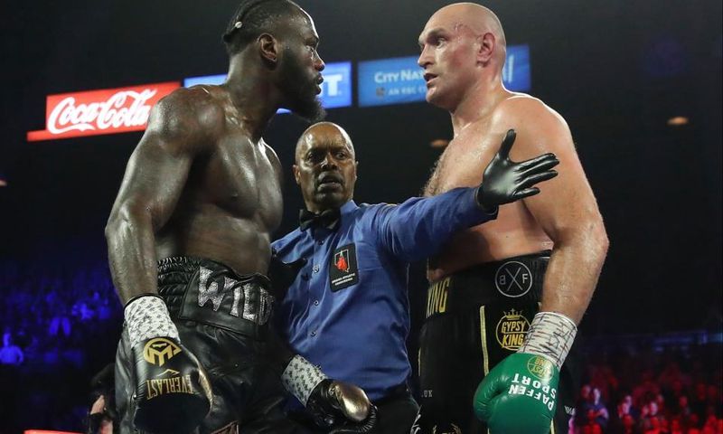 American boxer Deontay Wilder in the ring with British boxer Tyson Fury