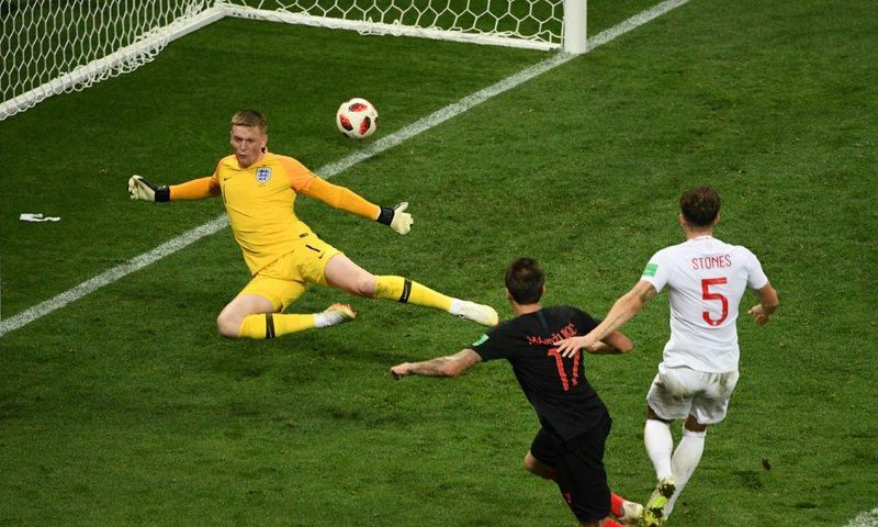 Semi-final flourish: Mario Mandzukic beats England's Jordan Pickford and Harry Maguire to put Croatia into the World Cup final.