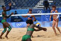 Kenya's Brackcides Khadambi (L), USA's Sarah Sponcil (back C) and USA's Kelly Claes (R) watch as Kenya's Gaudencia Makokha dives for the ball in their women's preliminary beach volleyball pool D match between the USA and Kenya during the Tokyo 2020 Olympic Games at Shiokaze Park in Tokyo on July 29, 2021. (Photo by Yuri CORTEZ / AFP) (Photo by YURI CORTEZ/AFP via Getty Images)