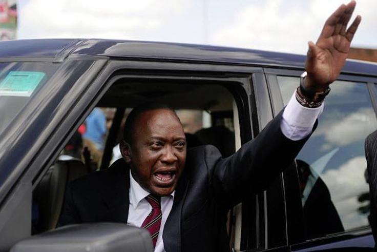President Uhuru Kenyatta waving from his car