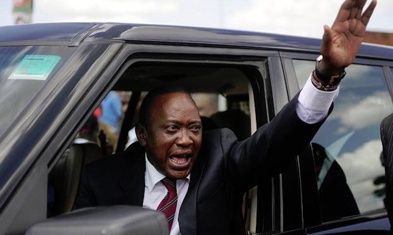 President Uhuru Kenyatta waving from his car