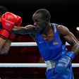 Kenya's Nicholas Okongo Okoth and Mongolia's Tsendbaatar Erdenebat fight during their men's feather (52-57kg) preliminaries boxing match during the Tokyo 2020 Olympic Games at the Kokugikan Arena in Tokyo on July 24, 2021. (Photo by Frank Franklin II /...
