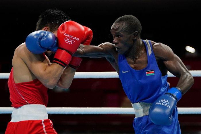 Kenya's Nicholas Okongo Okoth and Mongolia's Tsendbaatar Erdenebat fight during their men's feather (52-57kg) preliminaries boxing match during the Tokyo 2020 Olympic Games at the Kokugikan Arena in Tokyo on July 24, 2021. (Photo by Frank Franklin II /...