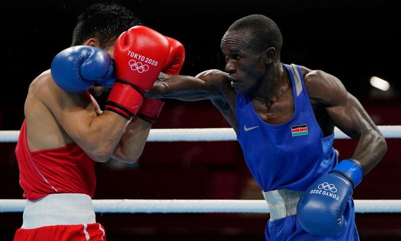 Kenya's Nicholas Okongo Okoth and Mongolia's Tsendbaatar Erdenebat fight during their men's feather (52-57kg) preliminaries boxing match during the Tokyo 2020 Olympic Games at the Kokugikan Arena in Tokyo on July 24, 2021. (Photo by Frank Franklin II /...