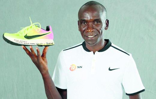 Eliud Kipchoge with his Rio Olympic shoe which was first displayed at the 2019 IAAF Heritage World Athletics Championships Exhibition in Doha, Qatar.