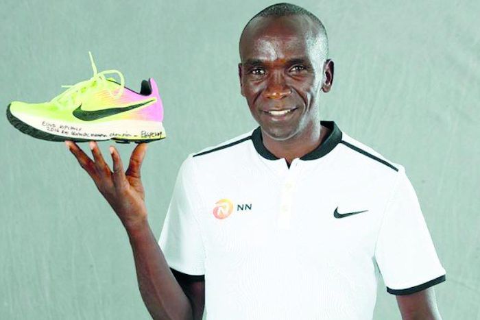 Eliud Kipchoge with his Rio Olympic shoe which was first displayed at the 2019 IAAF Heritage World Athletics Championships Exhibition in Doha, Qatar.