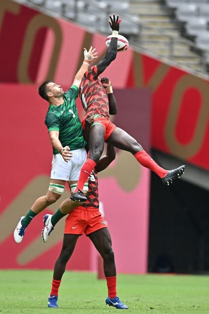 Ireland's Harry McNulty (L) fights for the ball with Kenya's Collins Injera (R) in the men's pool C rugby sevens match between Kenya and Ireland during the Tokyo 2020 Olympic Games at the Tokyo Stadium in Tokyo on July 27, 2021. (Photo by Ben STANSALL ...