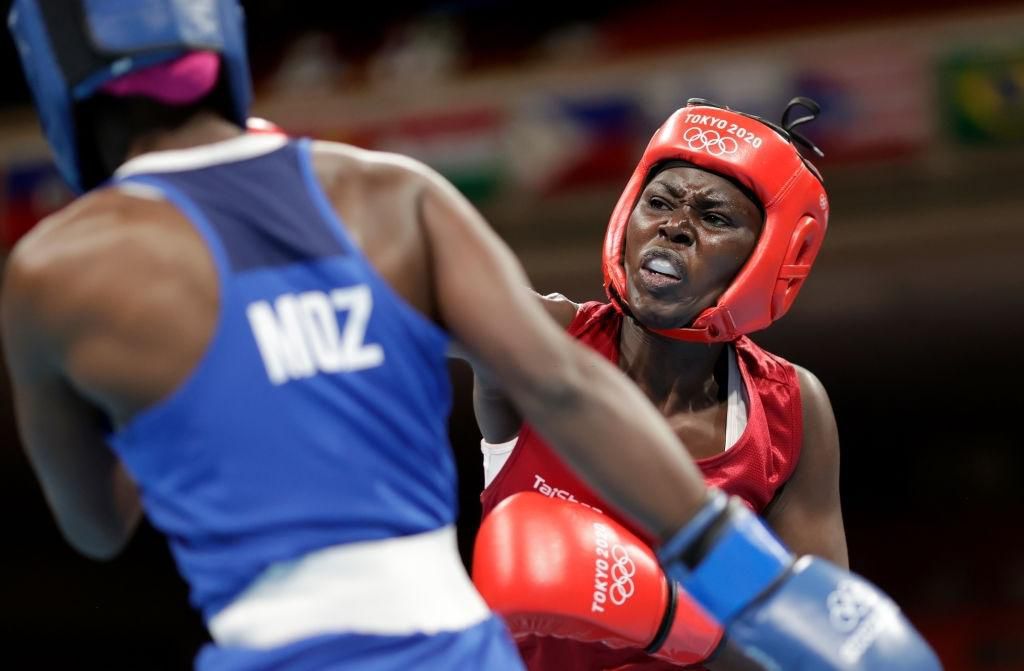Elizabeth Akinyi (red) of Kenya exchanges punches with Alcinda Helena Panguana of Mozambique during the Women's Welter (64-69kg) on day four of the Tokyo 2020 Olympic Games at Kokugikan Arena on July 27, 2021 in Tokyo, Japan. (Photo by Ueslei Marcelino - Pool/Getty Images)