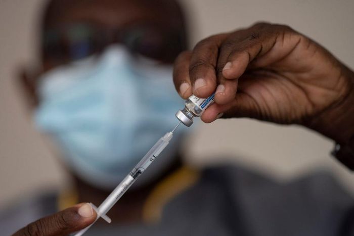 In this Wednesday, July 28, 2021 file photo, a health worker administers a dose of Janssen COVID-19 vaccine by Johnson & Johnson in the Medina neighborhood in Dakar, Senegal.