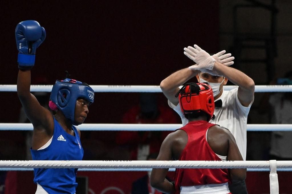 The referee gestures to Kenya's Elizabeth Akinyi (red) after she lost by KO her fight against Mozambique's Acinda Helena Panguana during their women's welter (64-69kg) preliminaries round of 16 boxing match during the Tokyo 2020 Olympic Games at the Kokugikan Arena in Tokyo on July 27, 2021. (Photo by Luis ROBAYO / AFP) (Photo by LUIS ROBAYO/AFP via Getty Images)