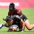 New Zealand's Stacey Fluhler is tackled by Kenya's Janet Okello during the women's pool A rugby sevens match between New Zealand and Kenya during the Tokyo 2020 Olympic Games at the Tokyo Stadium in Tokyo on July 29, 2021. (Photo by GREG BAKER / AFP) (...