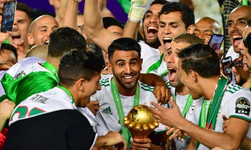 Captain Riyad Mahrez (C) holds the Africa Cup of Nations trophy after Algeria defeated Senegal in the 2019 final in Cairo