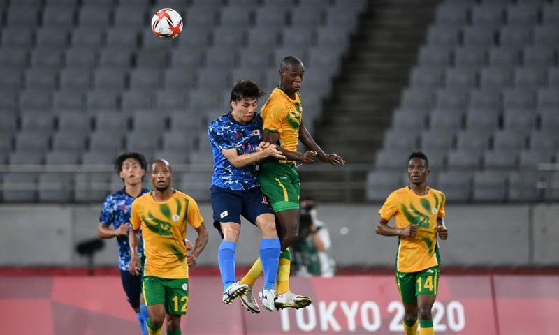High life: Japan midfielder Ao Tanaka jumps for a header with South Africa's Evidence Makgopa