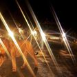 A lion walks past a queue of cars in Nairobi National Park on July 14, 2013. The wild lion brought traffic to a standstill near the entrance to the park as curious tourists risked breaking park rules by leaving after closing time to view the spectacle....