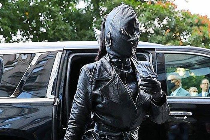 Kim Kardashian seen wearing a tied trench coat, leather pants and high heeled boots, along with a rhinestone “Hourglass” handbag. Photo by: Felipe Ramales / SplashNews.com