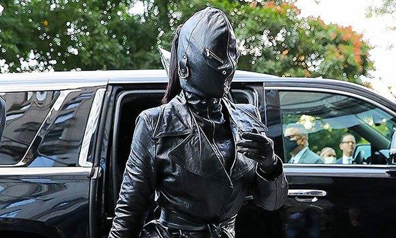 Kim Kardashian seen wearing a tied trench coat, leather pants and high heeled boots, along with a rhinestone “Hourglass” handbag. Photo by: Felipe Ramales / SplashNews.com