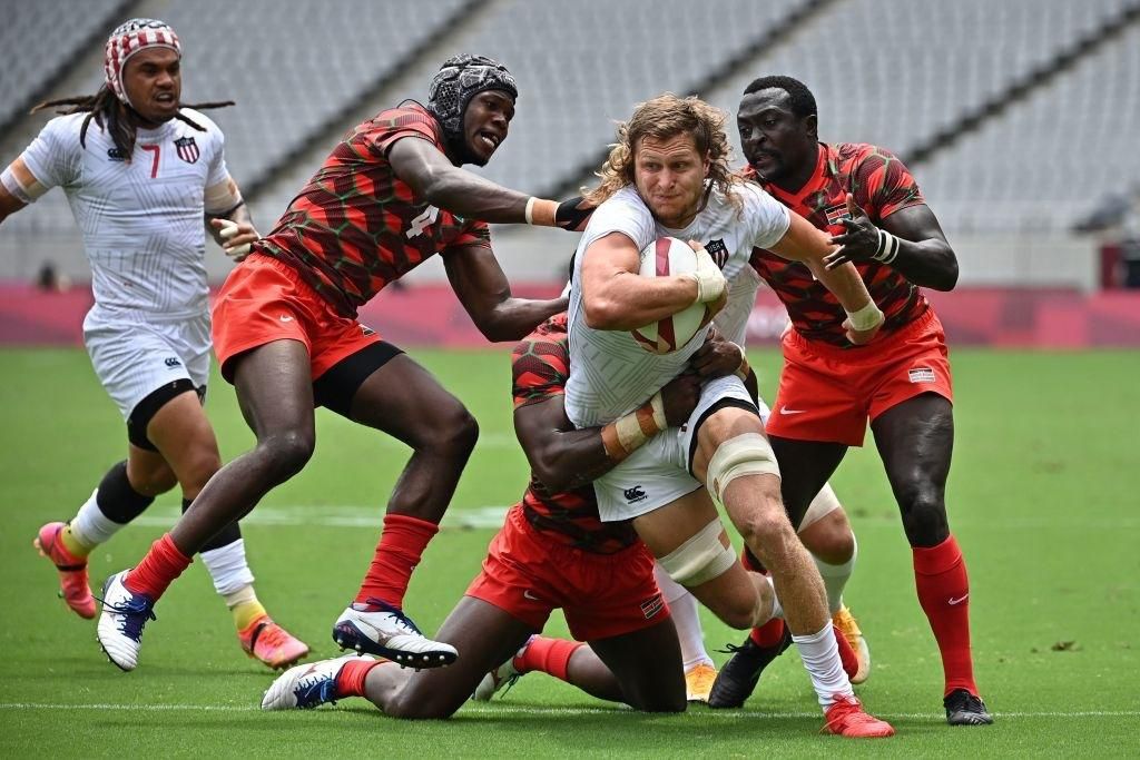 USA's Joe Schroeder (2nd R) tries to break through Kenya's defence in the men's pool C rugby sevens match between the USA and Kenya during the Tokyo 2020 Olympic Games at the Tokyo Stadium in Tokyo on July 26, 2021. (Photo by Ben STANSALL / AFP) (Photo by BEN STANSALL/AFP via Getty Images)