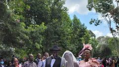 Deputy President William Ruto and wife Rachel walk June Ruto on the aisle at her wedding