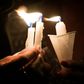 People hold candles as they pray during a candlelight vigil at the Immanuel Church for victims of the El Paso shooting