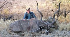 A man posing with his game trophy in Namibia