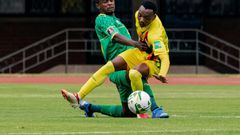 Zimbabwe forward Khama Billiat (R) contests possession with South Africa midfielder Teboho Mokoena (L) during a 2022 World Cup qualifier in Harare