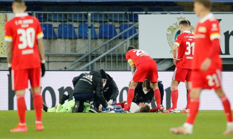 Worrying moment: Union Berlin goalkeeper Andreas Luthe and defender Julian Ryerson receive medical attention