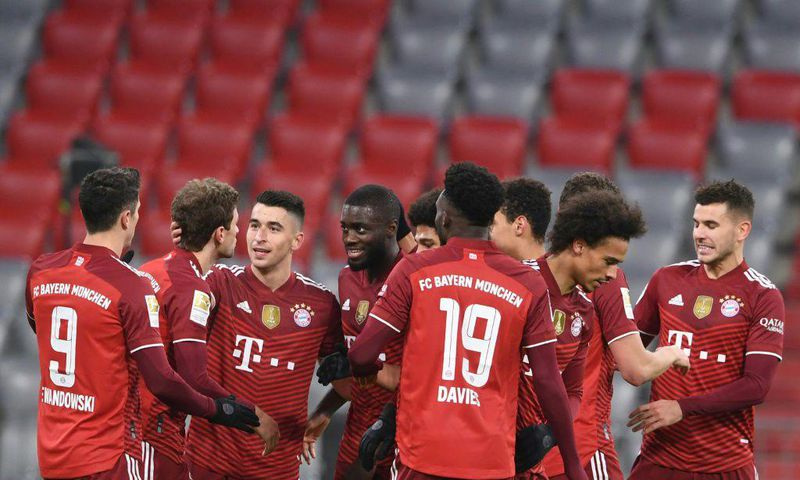 Thomas Mueller (2ndL) celebrates his assist for Bayern Munich defender Dayot Upamecano (4thL) on Friday
