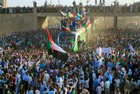 [FILE] Sudanese protesters cheer upon arriving from the capital Khartoum to the town of Atbara on December 19, 2019 to celebrate the first anniversary of the uprising that toppled Omar al-Bashir and to demand justice for slain protesters. - It was in the dusty streets of Atbara on the banks of the River Nile that Sudanese held their first rallies in December 2018 against a government decision to triple the price of bread. The protests swept across the African nation and by April, they had toppled Bashir, who had been in power for three decades. (Photo by ASHRAF SHAZLY / AFP) (Photo by ASHRAF SHAZLY/AFP via Getty Images)