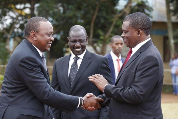 President Uhuru Kenyatta consoles National assembly speaker Justin Muturi during the burial service of the mother of National Assembly Speaker Justin Muturi in Embu County, looking on is DP WIlliam Ruto.
