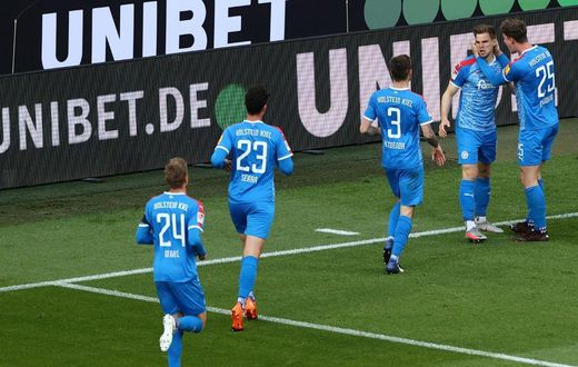 Man of the moment: Holstein Kiel defender Simon Lorenz (second right) celebrates his goal
