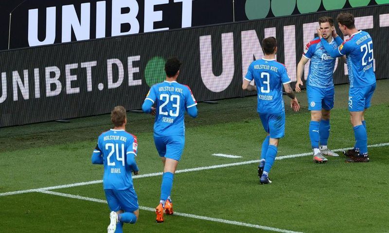 Man of the moment: Holstein Kiel defender Simon Lorenz (second right) celebrates his goal