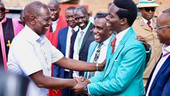 President William Ruto shaking hands with Kasmuel McOure wwhen they met during a Sunday service at A.I.C Kipkorgot church in Ainabkoi, Uasin Gishu County