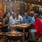 An AI-generated image depicting friends enjoy food, drinks, and laughter at an outdoor barbecue hangout.