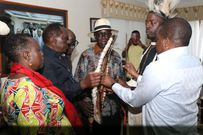 Raila Odinga receives the traditional instruments of power. Looking on is Siaya Senator Dr. Oburu Oginga and Ruth Odinga.